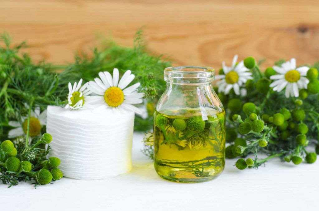 Flowers in bowl with herbal medicine