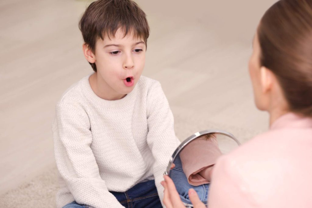 Woman performing sound therapy to child